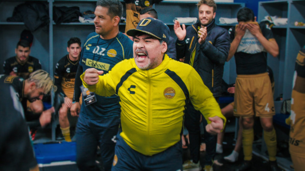 The manager celebrating with his players in Maradona In Mexico