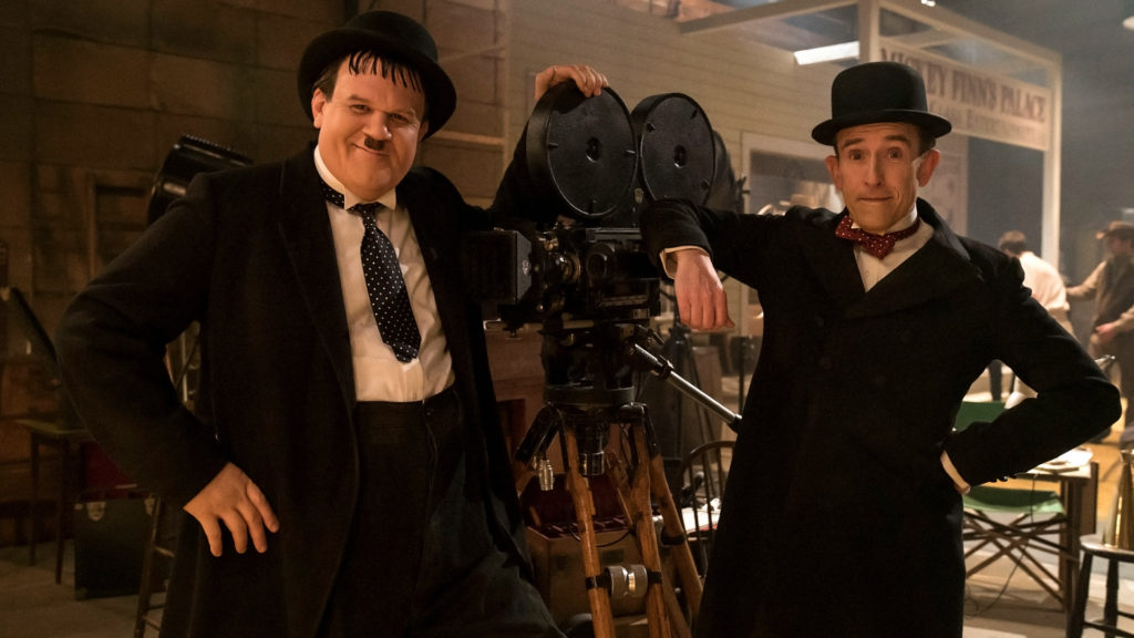 Stan and Ollie pose with a camera from the silent film era.