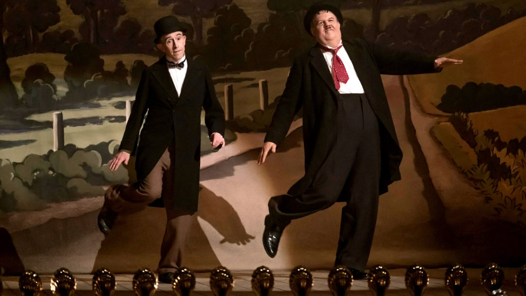 Stan and Ollie performing on stage.