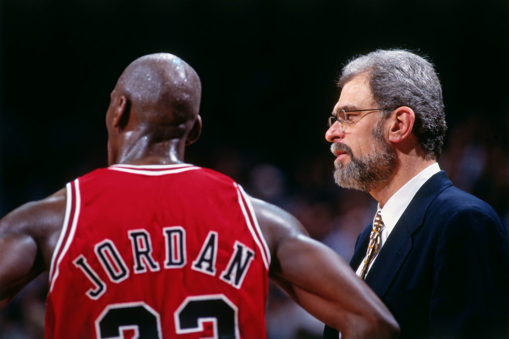 Michael Jordan and Phil Jackson of the Chicago Bulls look on against the Miami Heat on April 2, 1996 at Miami Arena in Miami.