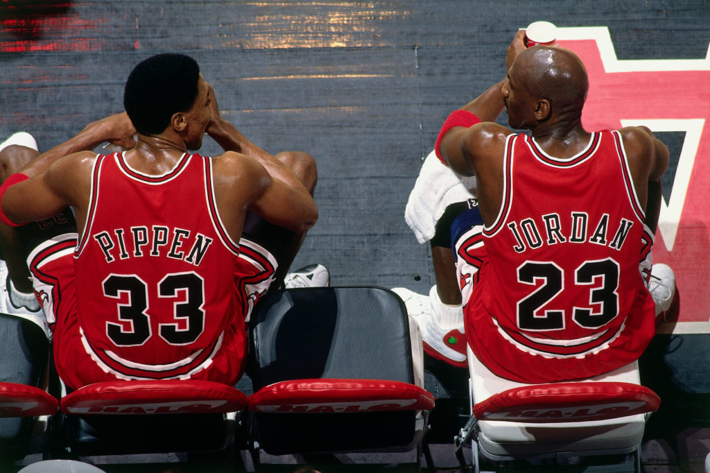 Scottie Pippen and Michael Jordan of the Chicago Bulls sit on the bench during the game against the Vancouver Grizzlies at General Motors Place on January 27, 1998 in Vancouver.