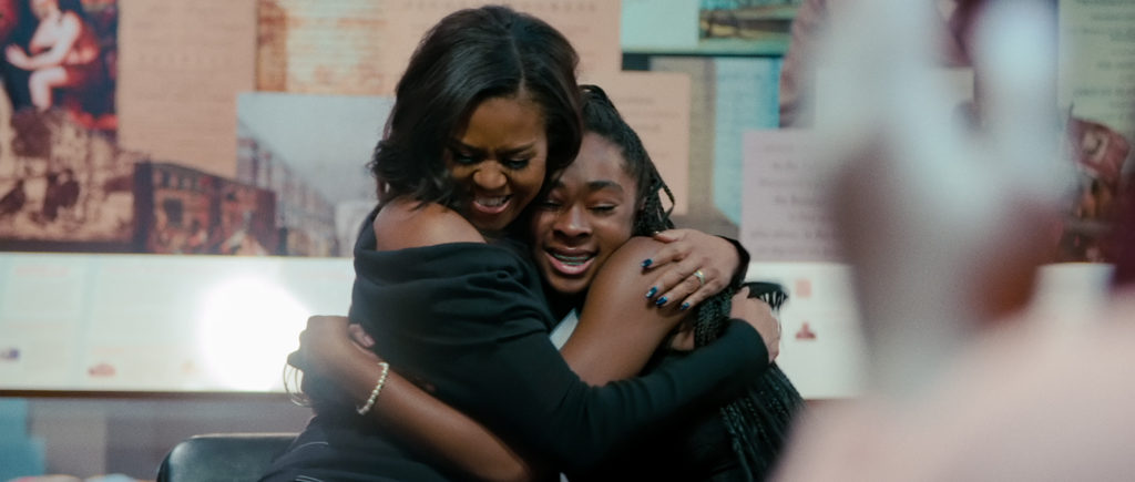 Michelle Obama hugging a student in Becoming.