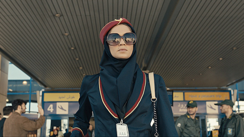 Tamar Rabinyan, dressed as an air stewardess, exits the airport, into Tehran, enemy territory.