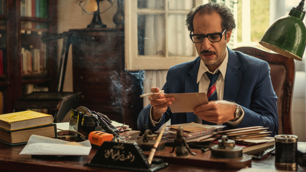 Dr. Refaat sits at his desk looking at a letter sent by his old friend, Louis C. Ferre in Paranormal.