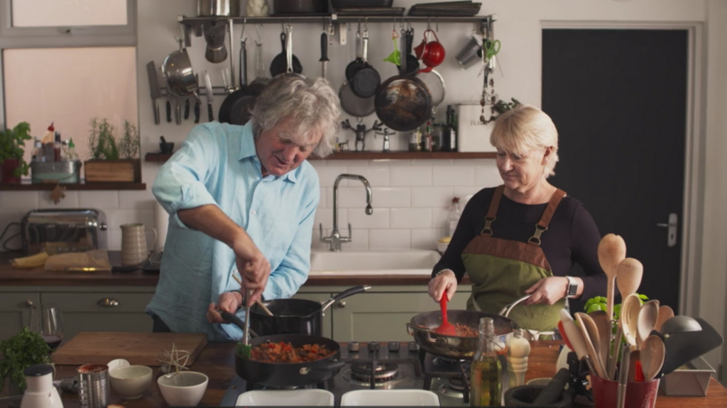 James May and Nikki Morgan cook over the stove in Oh Cook!