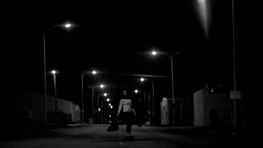 The Girl, skateboarding down an empty street in A Girl Walks Home Alone At Night